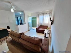 a living room with a couch and a table at CASA DE VERANEIO PERUIBE in Peruíbe