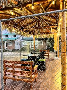 a boy sitting on a bench in a batting cage at Cabaña Cangrejito Olon in Olón