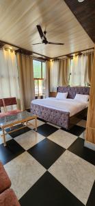 a bedroom with a large bed and a couch at Cozy Haven in Dehradun