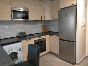 a kitchen with a stainless steel refrigerator and a dishwasher at PIso recién reformado y espacioso in Haro