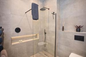 a shower with a glass door in a bathroom at Ultra Stylish Apt set in an affluent location in Poole