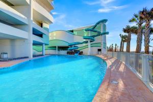 a swimming pool with a slide in front of a building at Turquoise Place By Liquid Life in Orange Beach