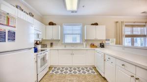 a white kitchen with white cabinets and a sink at 321 Willow Bend condo in North Myrtle Beach