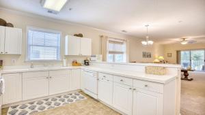 a kitchen with white cabinets and a white counter top at 321 Willow Bend condo in North Myrtle Beach