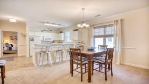 a kitchen and dining room with a table and chairs at 321 Willow Bend condo in North Myrtle Beach