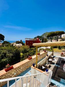a house with a balcony with a view of the ocean at Capri Joy in Capri