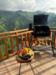 a basket of fruit sitting on a deck with a grill at Northland Bungalows in Çayırdüzü