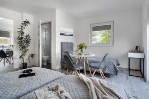 a bedroom with a bed and a table and chairs at u Basi in Mrzeżyno
