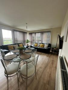 a living room with tables and chairs and a couch at Down Town Pad*2Bed&Free Parking* in Glasgow