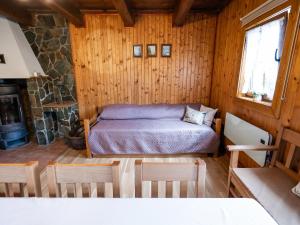 a bedroom with a bed in a wooden room at Drevenička v Durčinej - Magdaléna in Ďurčiná