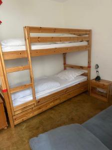 two bunk beds in a room with a ladder at Appartement avec grande terrasse Loèche les Bains in Leukerbad