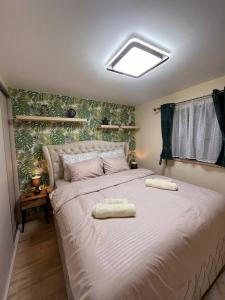 a bedroom with a large bed with two pillows on it at Etna planinska kuca in Bajina Bašta