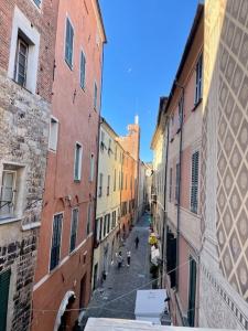 a view of an alley between two buildings at Residenza d'Epoca Senatore Rolandi Ricci in Albenga +31 photos