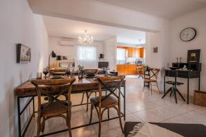 a kitchen and dining room with a table and chairs at Soul V. House in Kos
