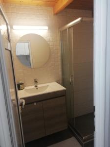 a bathroom with a sink and a shower at SPYROS STONE house in Preveza +15 photos