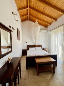 a bedroom with a bed and a wooden ceiling at Avra Studios in Elafonisos