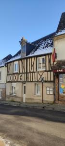an old building on the side of a street at Appartement cosy plein centre in Conches-en-Ouche
