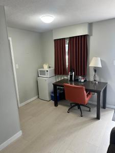 an office with a desk and a chair and a table at Travelodge by Wyndham Langley in Langley