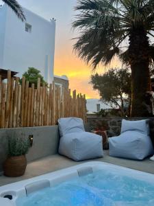 a hot tub sitting next to a wooden fence at Levantes House Mykonos in Ano Mera