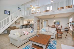 a living room with two couches and a table at Sharkey's by Pristine Properties Vacation Rentals in Cape San Blas