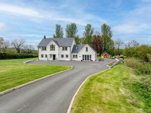 a large white house on a road at Parc Y Deri in Aberystwyth