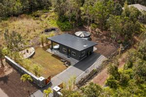 an overhead view of a black house in the forest at 5-Star Luxury Sauna-Spa Retreat Near Volcano Nat'l in Volcano
