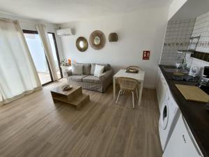 a living room with a couch and a table at Apartamentos La Florida in Puerto del Carmen