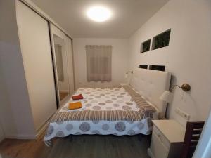 a small bedroom with a bed and a refrigerator at Torremolinos Playa Carihuela in Torremolinos
