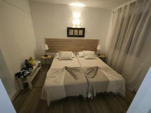 a bedroom with a large bed with a light above it at Apartamentos La Florida in Puerto del Carmen