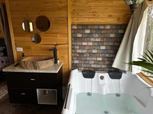 a bathroom with a white tub and a sink at Entre hayuelos in Iza +11 photos