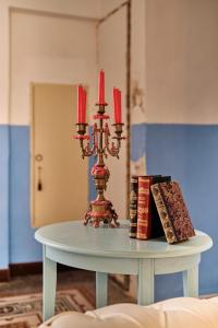 una mesa con una vela y libros en ella en Palazzo Scarciglia, en Minervino di Lecce