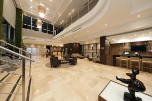 a lobby of a hotel with a restaurant at Victoria Hotel and Suites Panama in Panama City
