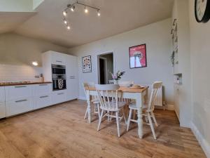 a kitchen and dining room with a table and chairs at Contemporary apartment in Cromer in Cromer