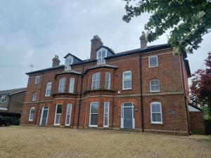 a large red brick building with white windows at Contemporary apartment in Cromer in Cromer
