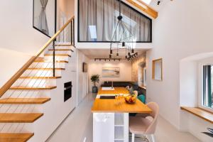 a kitchen and living room with a staircase and a table at Apartment Nezi in Pučišća