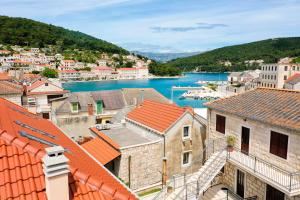 a view of a town with a river and buildings at Apartment Nezi in Pučišća