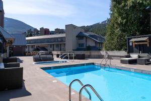 a large swimming pool in front of a building at Adara Hotel in Whistler