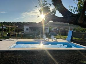 una piscina en un patio con luz solar en Valle de la Rosa en Prado del Rey