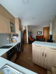 a kitchen with a sink and a stove top oven at Mi Casita de Gredos in Hoyocasero