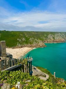 a view of a beach and the ocean at Immaculate 2-Bed Lodge in Hayle in Hayle