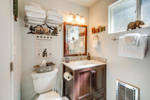 a bathroom with a sink and a toilet and a mirror at 5 Mi to Big Bear Lake Pet-Friendly Gem Near Hikes in Sugarloaf +18 photos