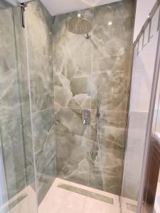 a shower in a bathroom with a glass door at Casa Maribella Cattolica in Cattolica