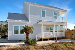 a white house with a black roof at Casa Linda by Pristine Properties Vacation Rentals in Mexico Beach +80 photos