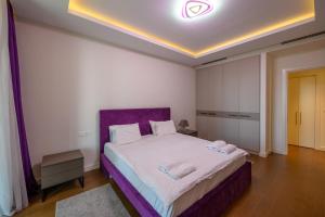 a bedroom with a bed with two towels on it at Luxury apartment with Pool&Gym in Belgrade +13 photos