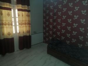 Saint-ArnaudGuest apartment for a family or for family members的一间设有窗帘、床和窗户的房间