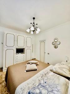 1 dormitorio con 2 camas y ventilador de techo en Capri Joy, en Capri