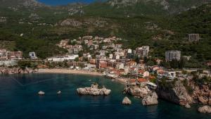 an aerial view of a town on the water with buildings at Apartments Raymond in Sveti Stefan