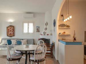 a kitchen and living room with a table and chairs at Cycladic home in Paros in Kampos Paros
