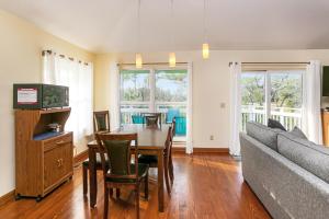 a living room with a table and a couch at Oceans of Time by Pristine Properties Vacation Rentals in Indian Pass +49 photos