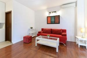 a living room with a red couch and a table at House Villa Danica on the hills in Srinjine